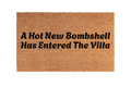 The Doormat District doormat with text 'A Hot New Bombshell Has Entered The Villa' 