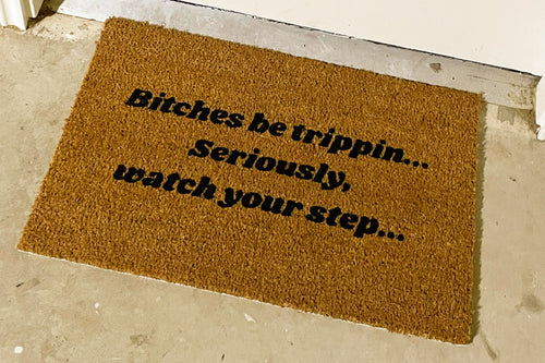 The Doormat District doormat with text "Bitches Be Trippin, Seriously, Watch Your Step"