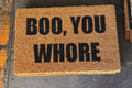 The Doormat District doormat with text 'BOO, YOU WHORE'