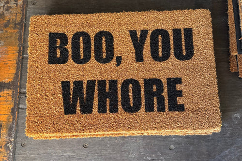 The Doormat District doormat with text 'BOO, YOU WHORE'