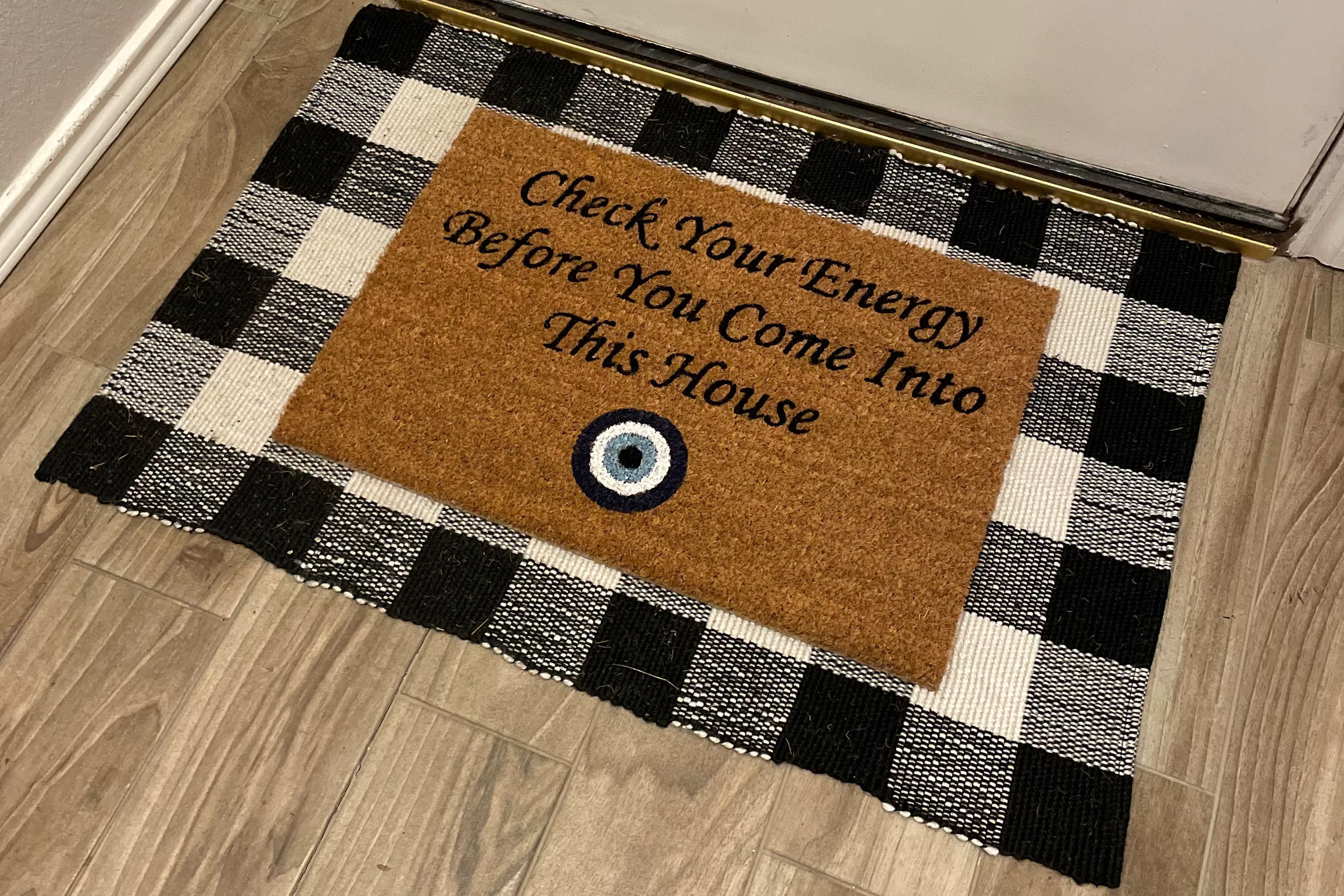 The Doormat District doormat with text "Check Your Energy Before You Come Into This House" with Blue Evil Eye