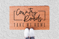 The Doormat District doormat with 'Country Roads Take Me Home' text