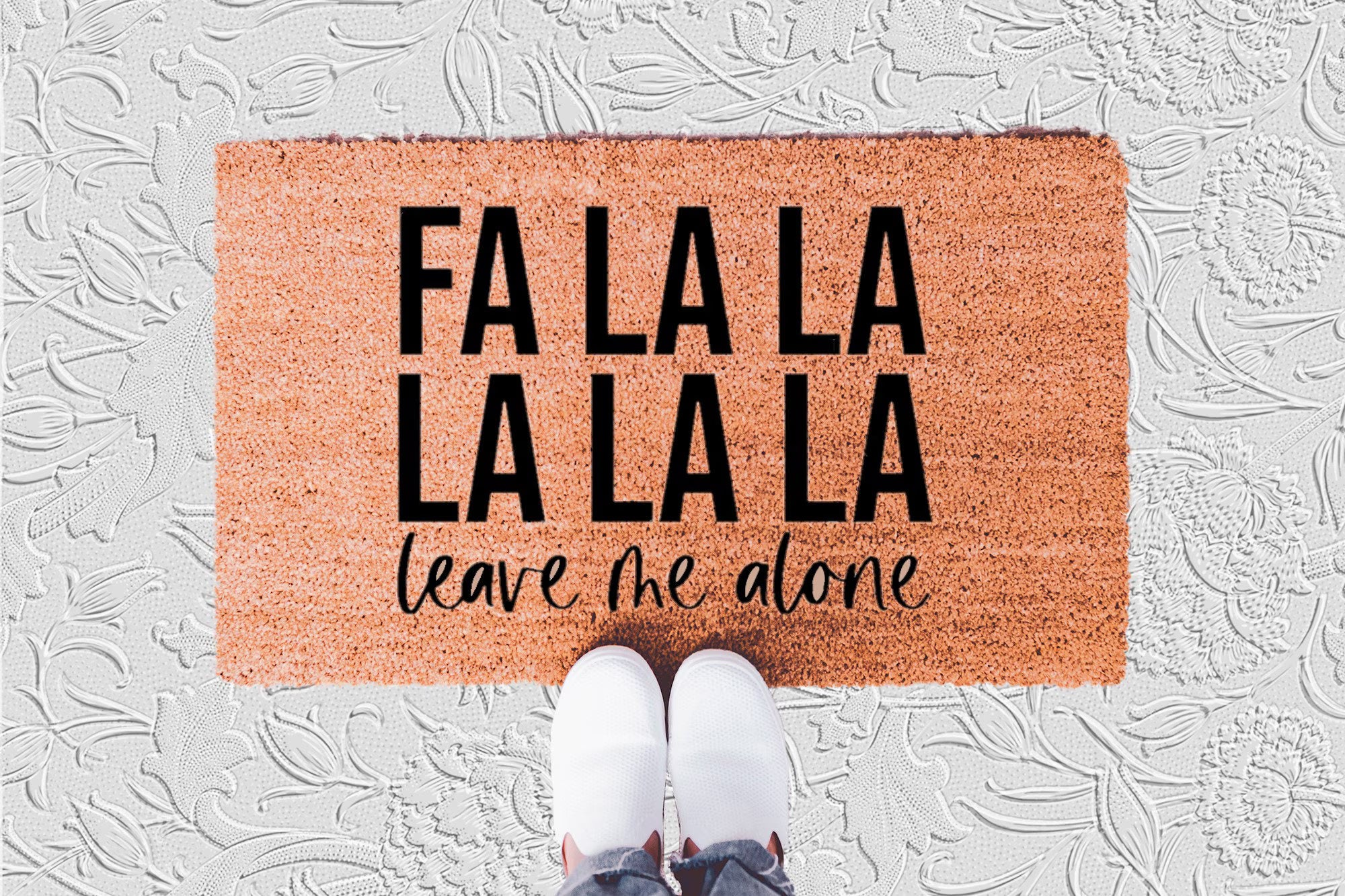The Doormat District doormat with text "Fa La La La La La Leave Me Alone"