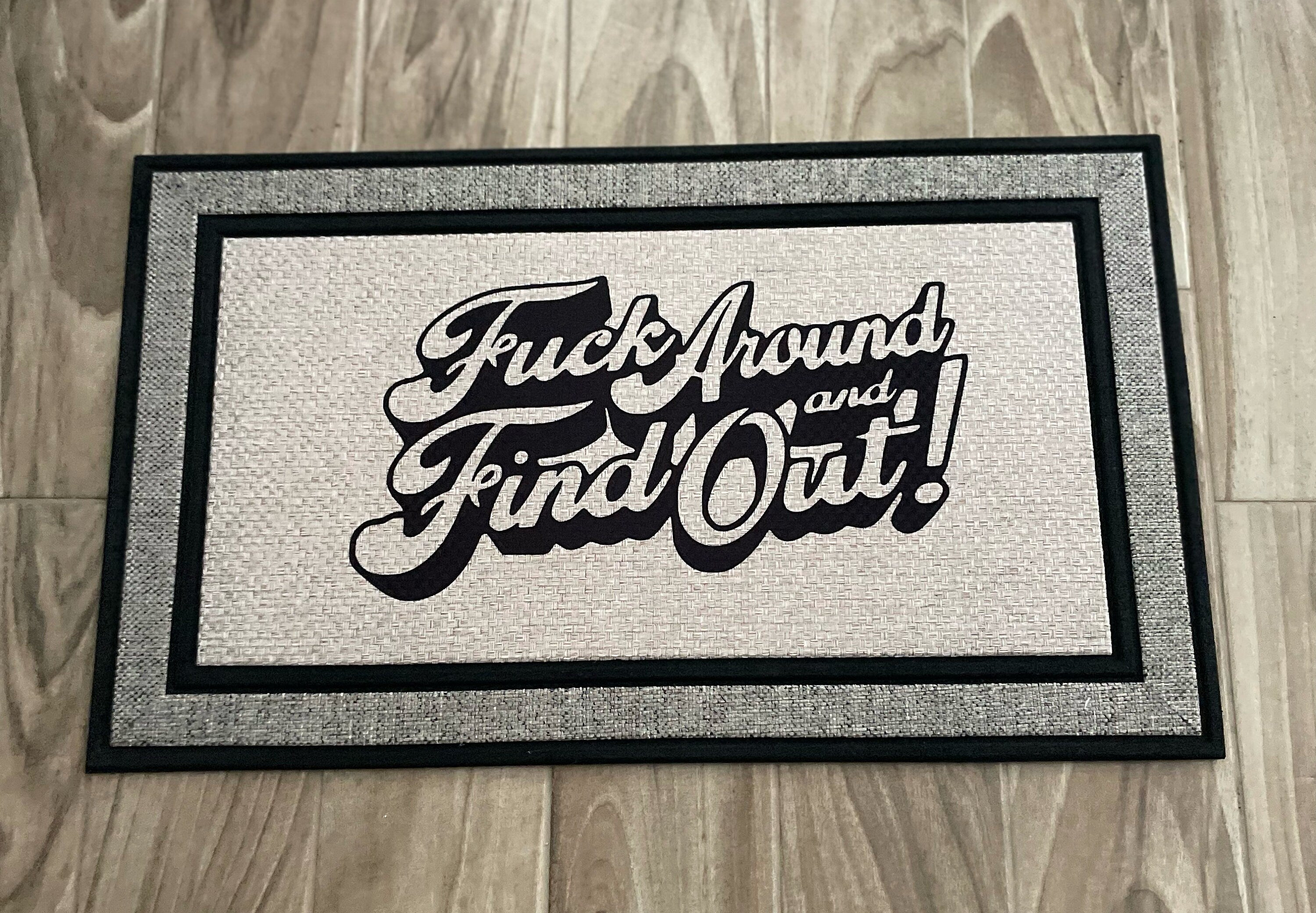 The Doormat District doormat with text "Fck Around And Find Out"