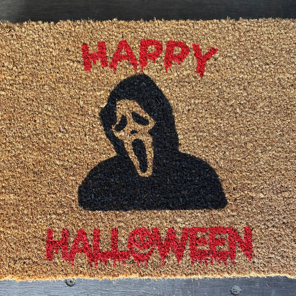 The Doormat District doormat with text 
'Happy Halloween' and Ghostface Image