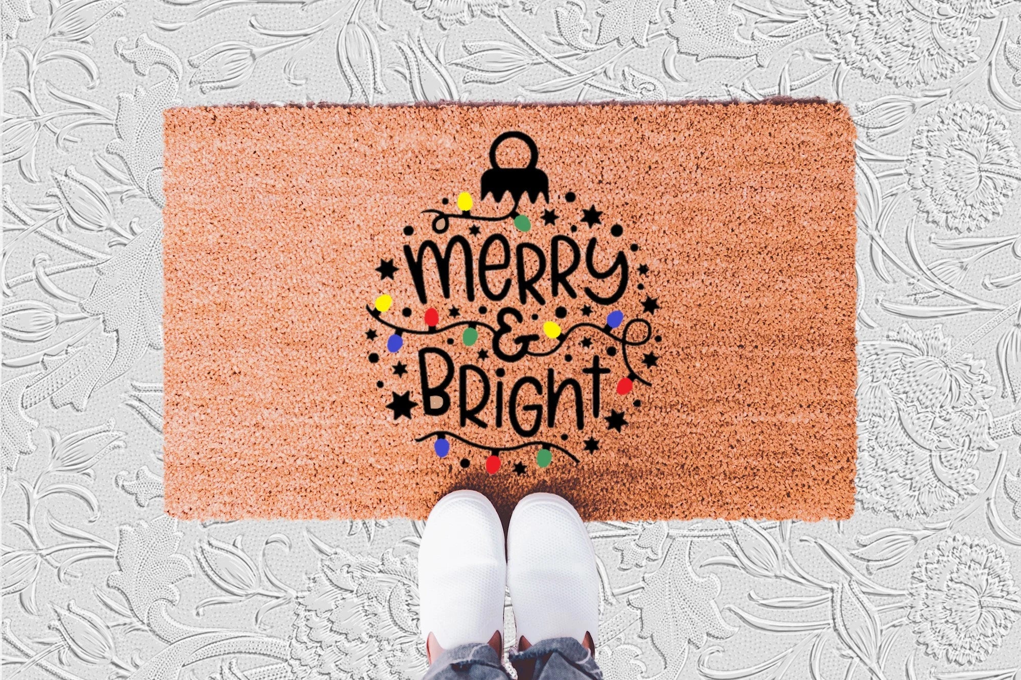 The Doormat District doormat with "Merry & Bright" on a  Christmas Ornament 