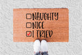 The Doormat District doormat with humorous text 'Naughty, Nice, I Tried' 