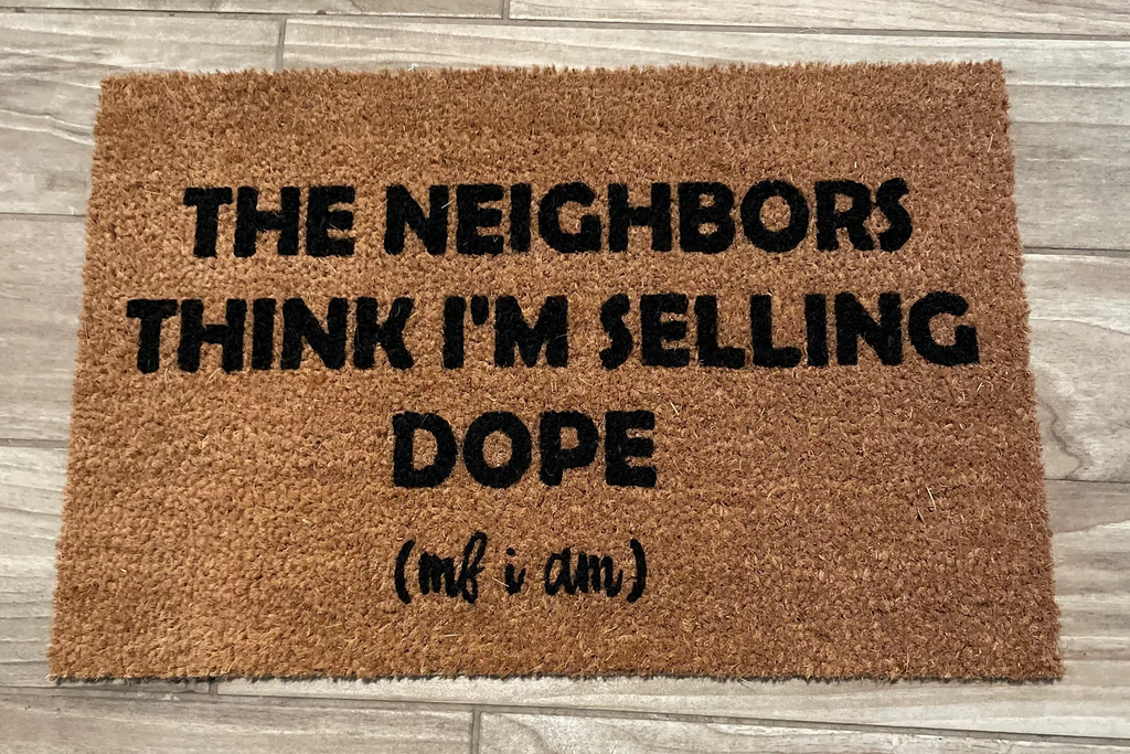 The Doormat District doormat with the quote The Neighbors Think I'm Selling Dope 