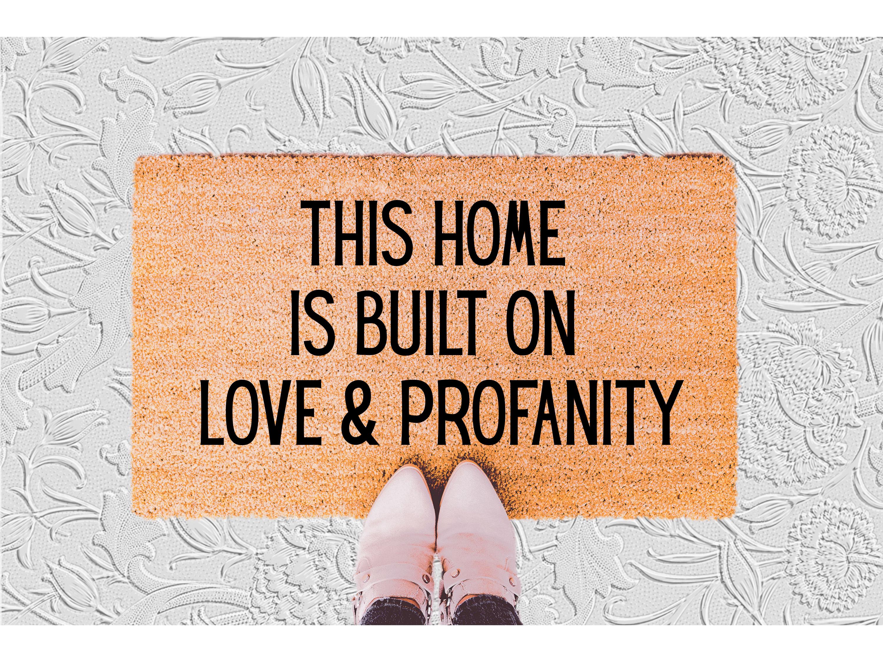 The Doormat District doormat with text 'This home is built on love & profanity'