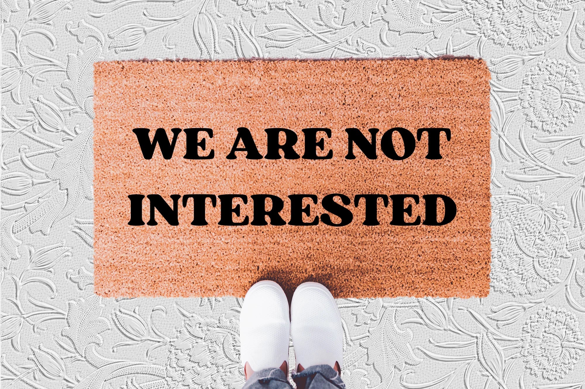 The Doormat District doormat with 'WE ARE NOT INTERESTED' text 