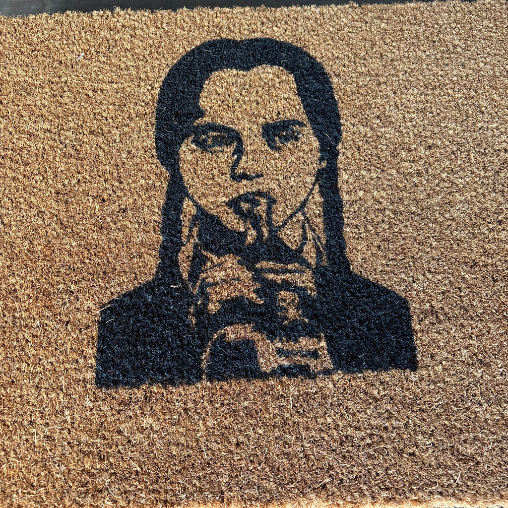 The Doormat District doormat with Wednesday Addams Image