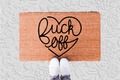 The Doormat District doormat with 'Fuck off' in a heart shape 